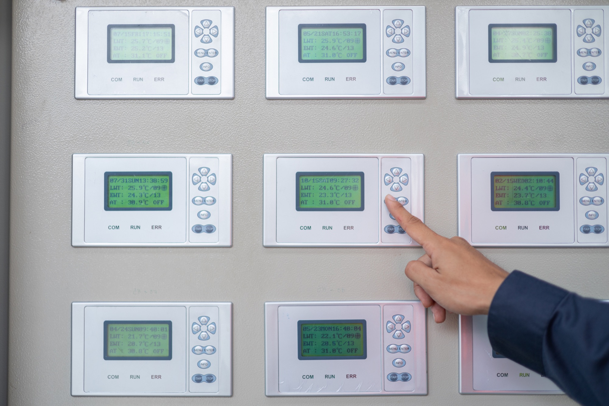 Technician working at a building automation control panel