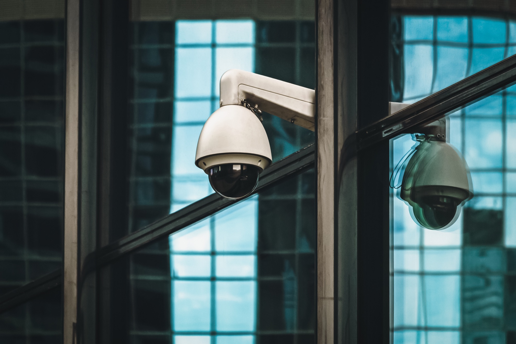 Exterior dome security camera on a commercial facade