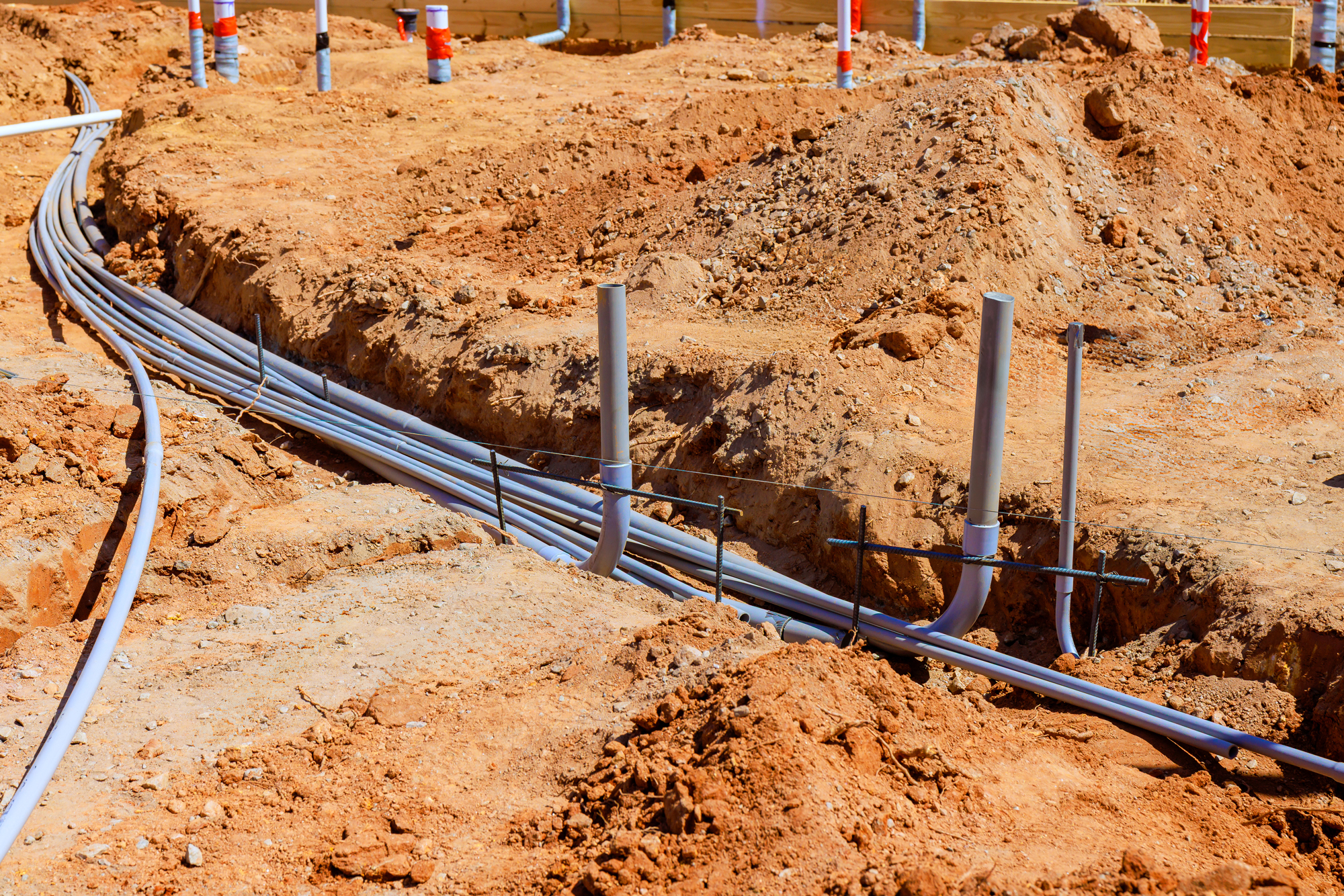 Underground utility trench and conduit infrastructure at a commercial site